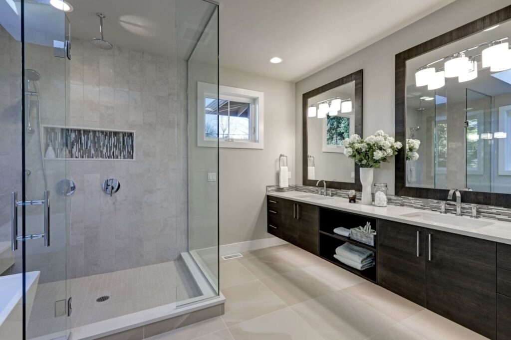 walk-in shower with glass enclosure; wooden vanity