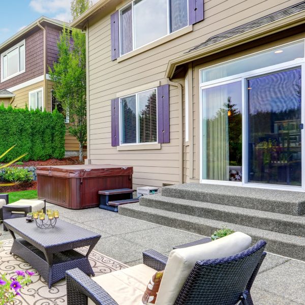 Cozy patio area with settees and table, decorated with flower pot